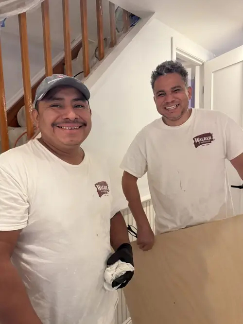 Two crew members sharing a laugh in the middle of a project